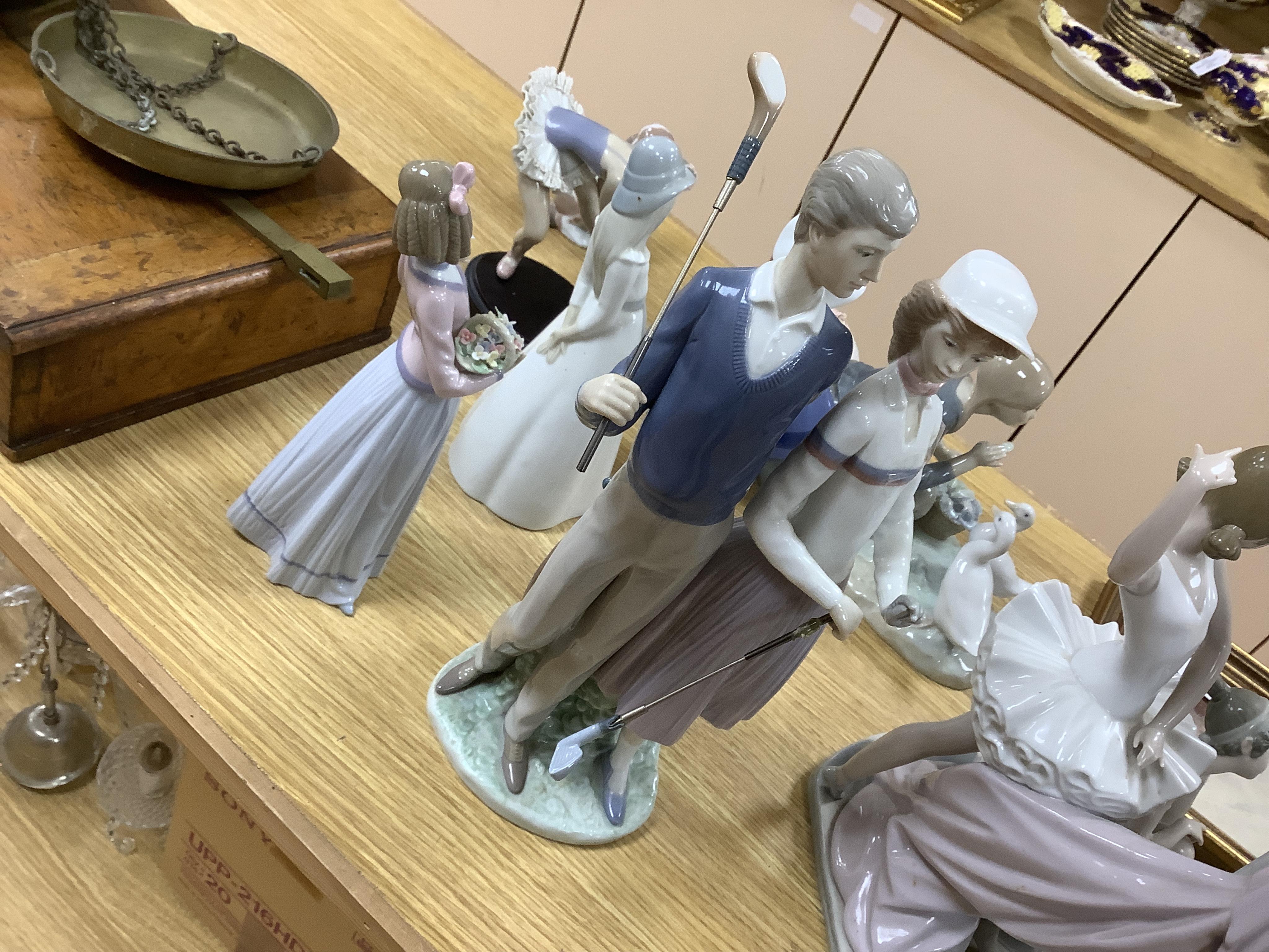 A large Lladro figure group of three ballet dancers by a tall floral column and eight other Lladro figures including a model of a bell. Tallest figure group 45cm high. Condition - golfer group, golf clubs broken.